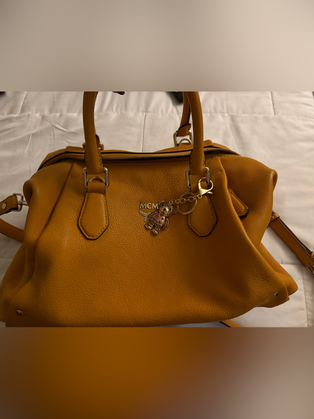 MCM  color is approximately mustard like  color/Leather Satchel with Charm